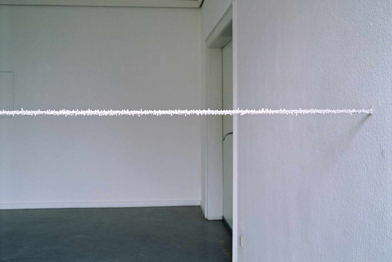 „Stuckleiste #2“; 1999; gespanntes Stahlseil, Gips; (extended steel wire,plaster;1900 cm, ∅ 3 cm (749", ∅ 1"); Ausstellung „Zeichnung und Raum“ (Exhibition "Zeichnung und Raum); Kunsthaus Nürnberg